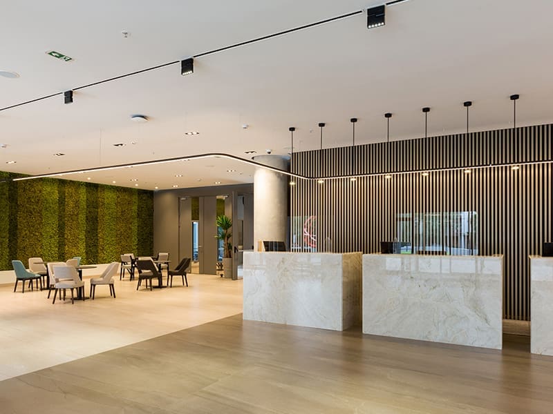 large room with tables, chairs, and a bar